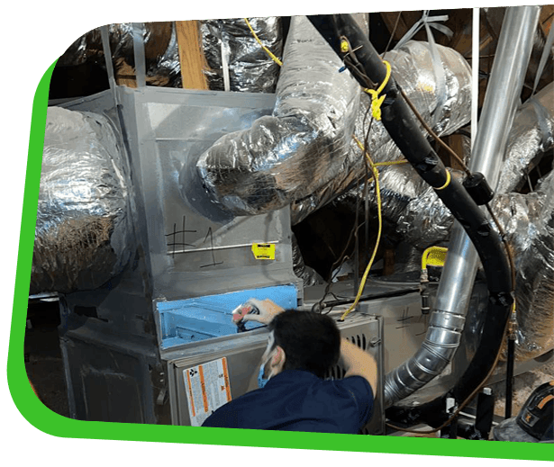 Technician performing professional HVAC cleaning service in North Carolina removing dust buildup from ductwork